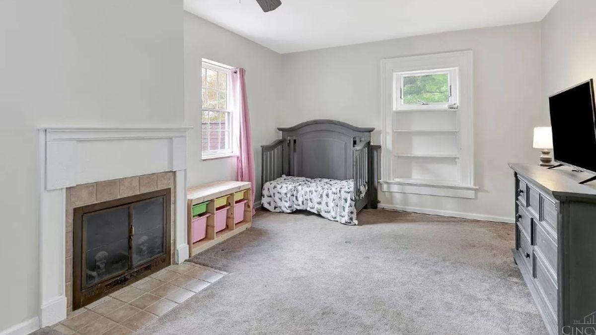 Notice the Built-In Shelves by the Fireplace in This Neutral Nursery