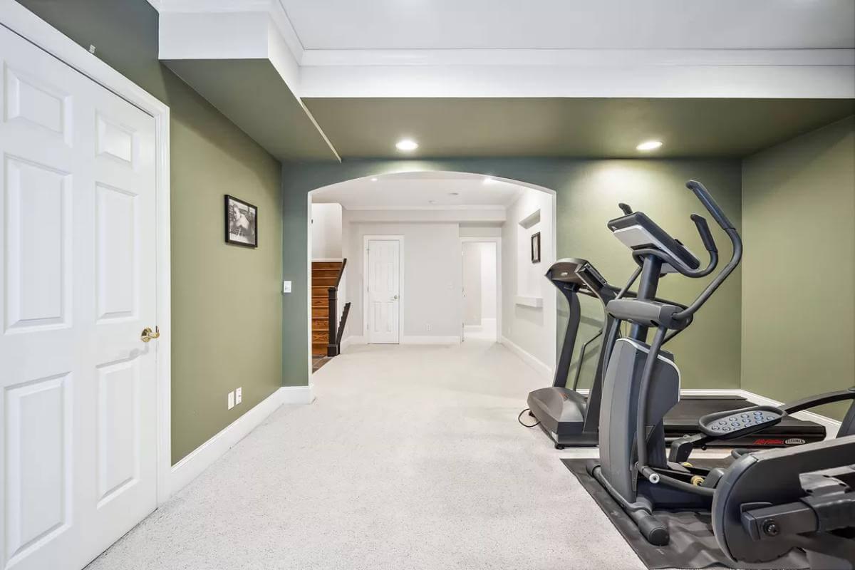 Practical Home Gym Space with a Refreshing Green Accent Wall