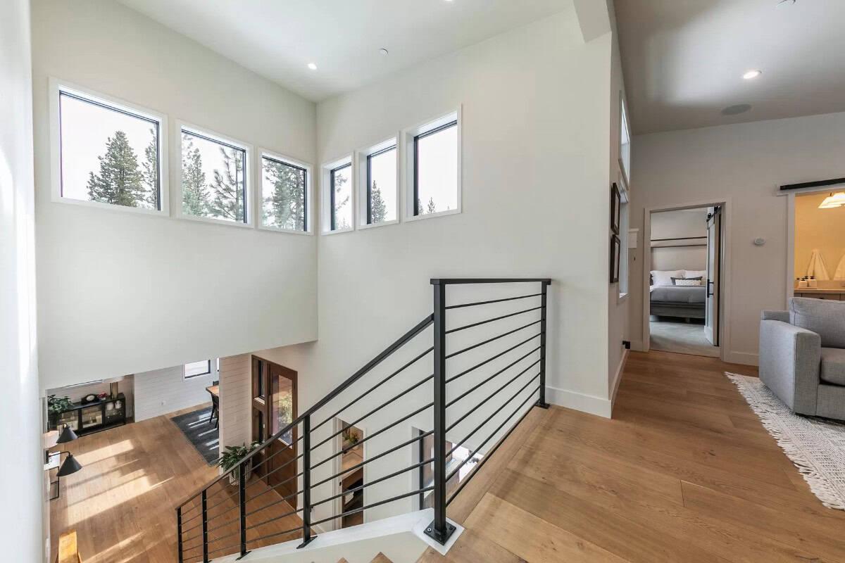 Explore the Open Staircase and Abundant Natural Light in This Landing Area