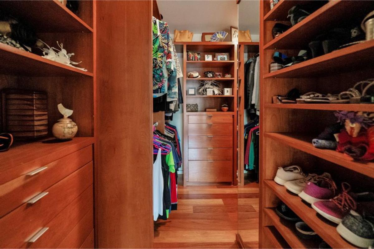 Walk-In Closet with Rich Wooden Shelving and Plenty of Storage