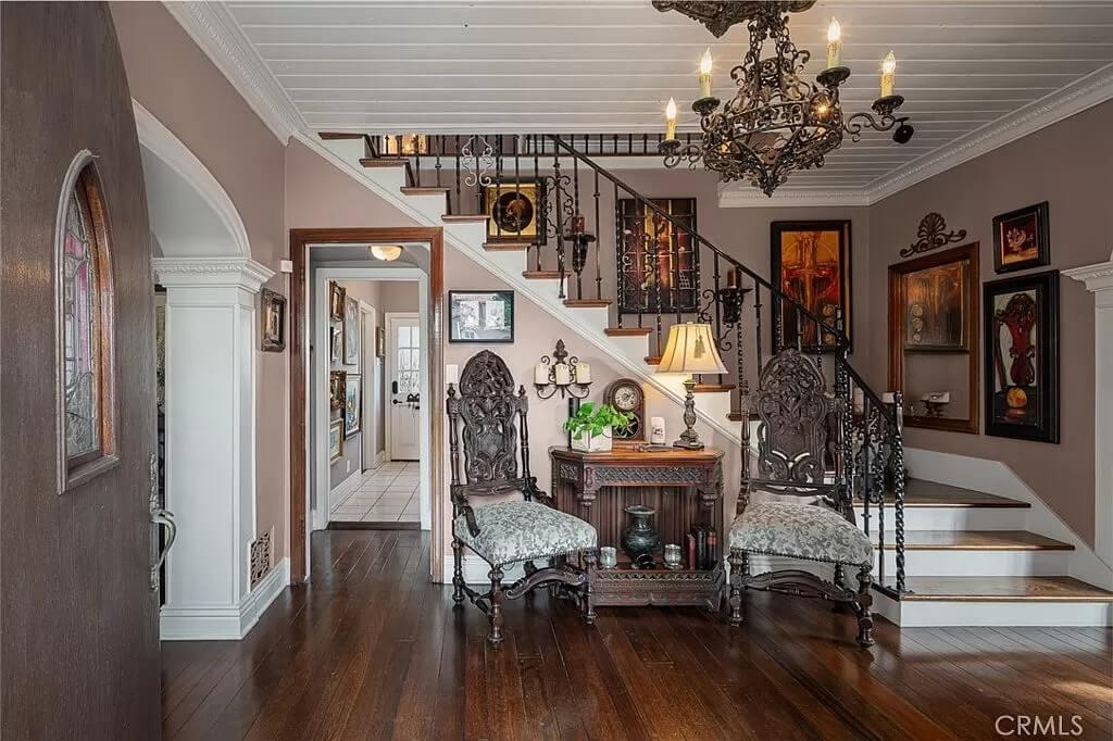 Step into This Richly Adorned Entryway with Intricate Chandeliers