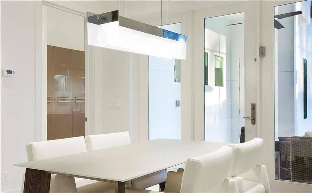 Minimalist Dining Space Highlighting a Futuristic Light Fixture