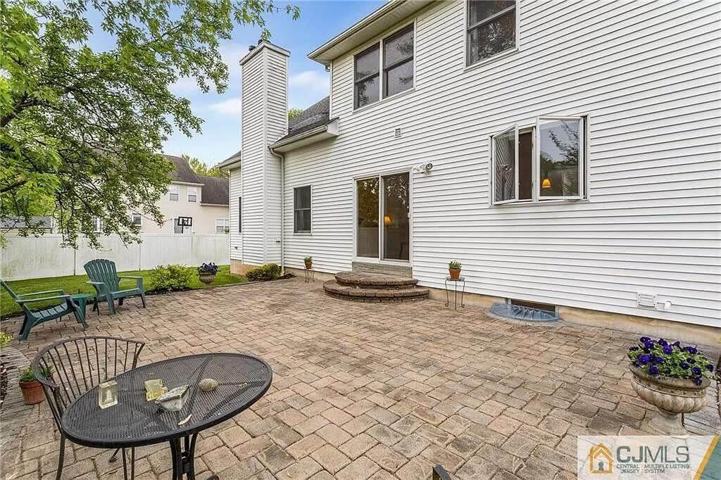 Spacious Patio with Classic Brick Pavers and Ample Seating