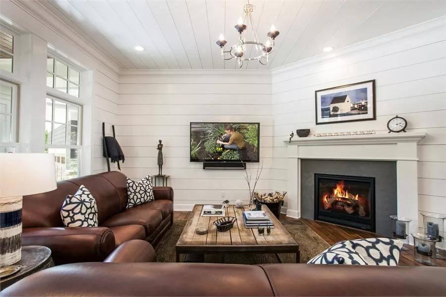 Craftsman Living Room with Plank Walls and Leather Sofas