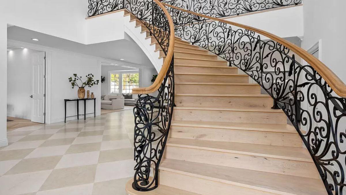 Grand Curved Staircase Steals the Show With Intricate Ironwork