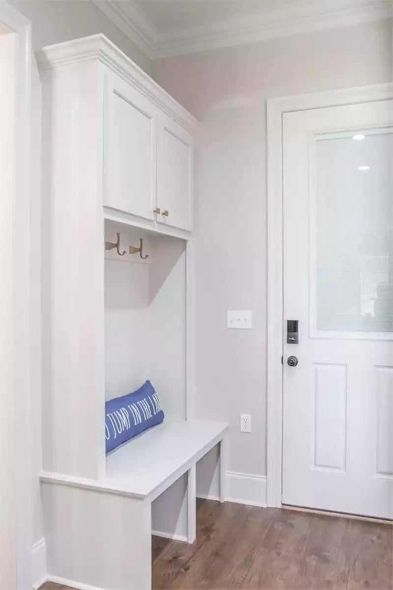 Peek Into This Craftsman Mudroom Highlighting a Practical Bench and Hooks