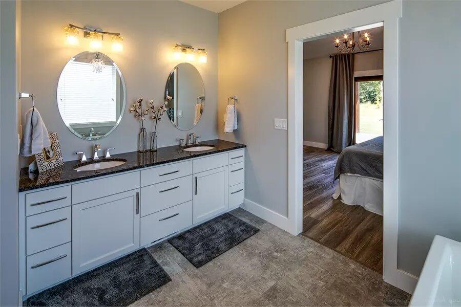 Dual Sinks and Oval Mirrors Elevate This Crisp Bathroom