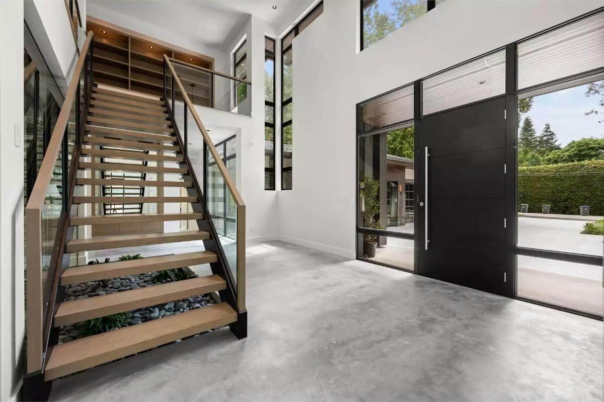 Take a Look at This Sleek Floating Staircase with Glass Railings