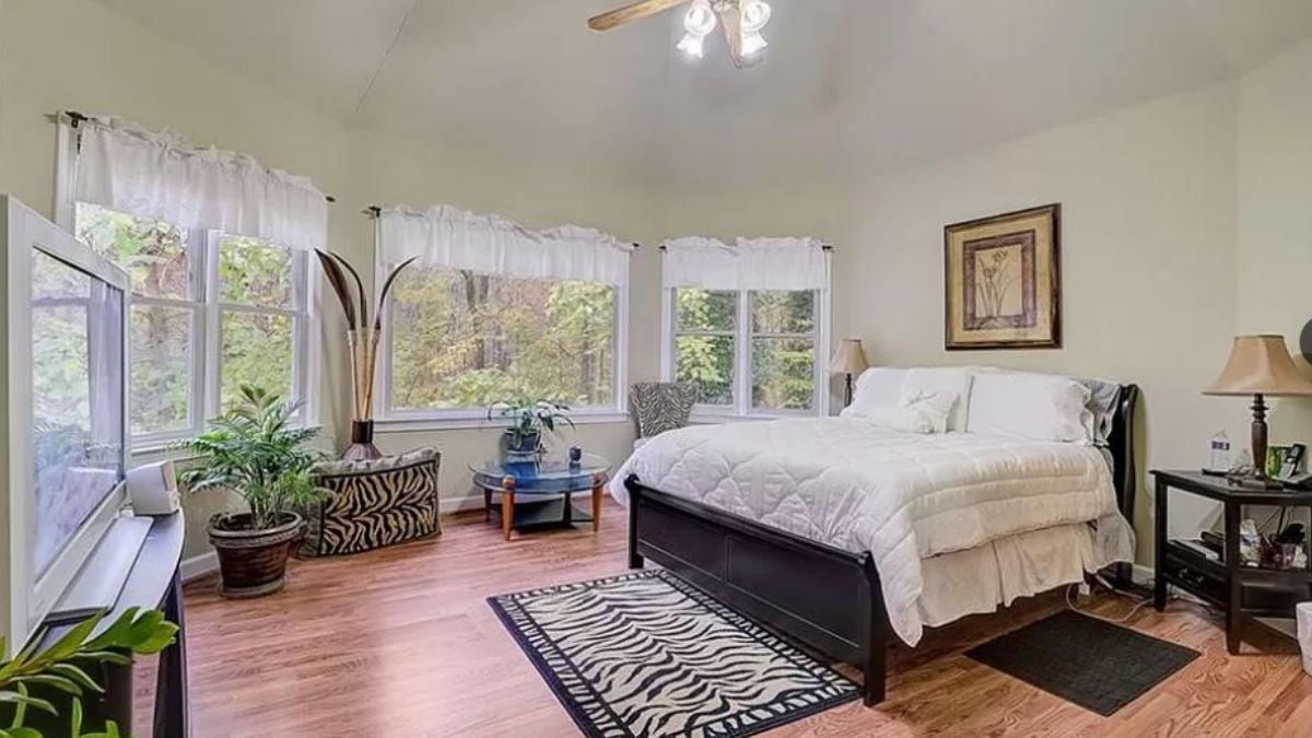Light-Filled Bedroom with Zebra Accents and Verdant Views