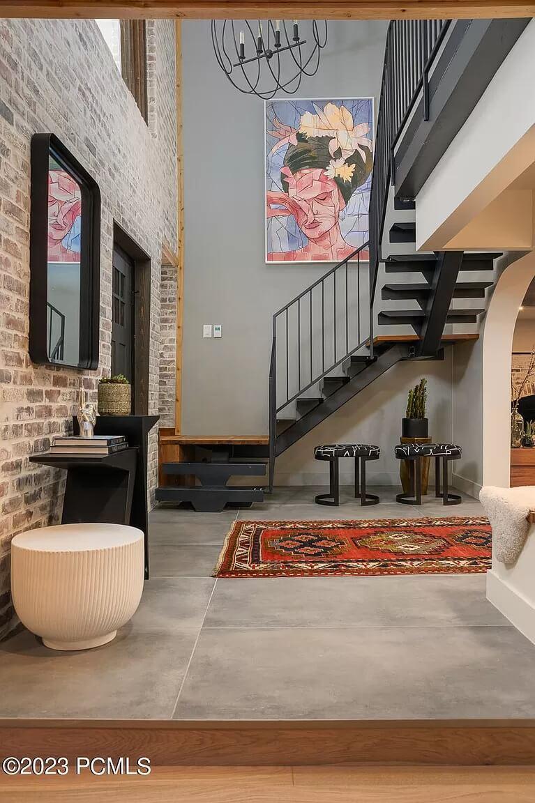 Stylish Staircase with Industrial Railing and Brick Accents