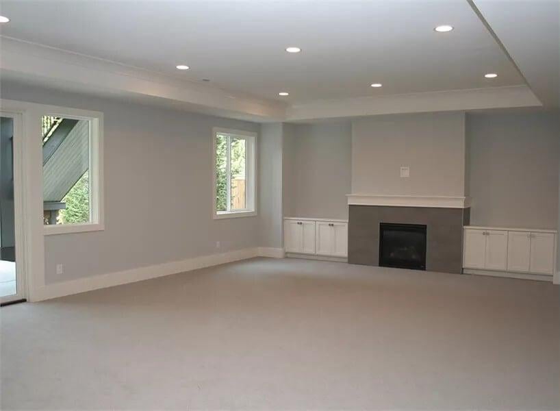 Expansive Living Room with Classic Built-in Cabinets Flanking the Fireplace