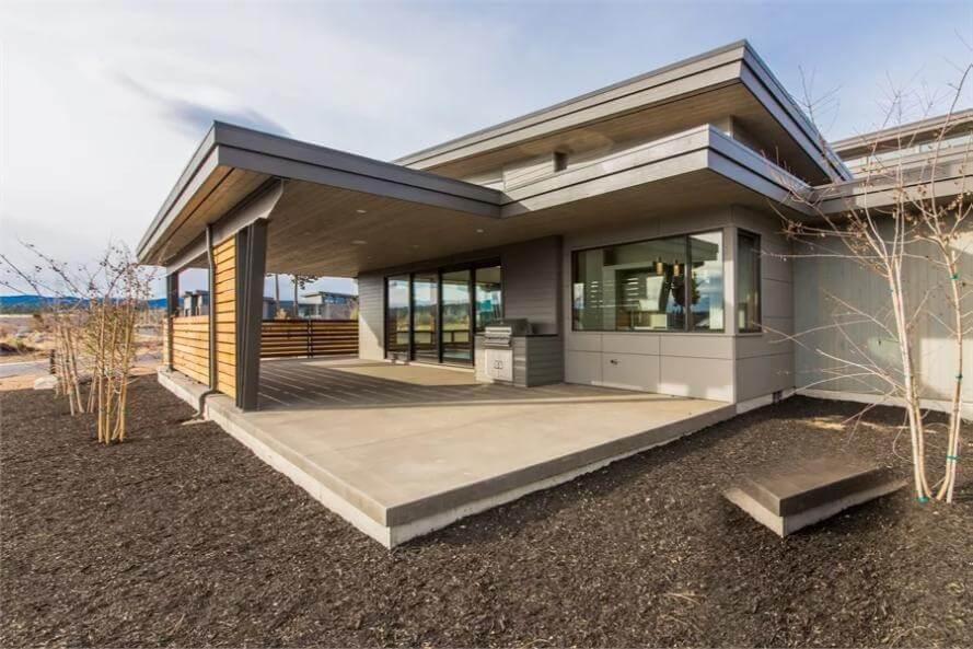 Explore This Modern Patio with Sleek Overhang and Wood Accents