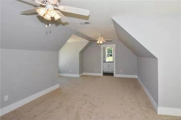 Explore the Potential in This Spacious Attic Room with Sloped Ceilings