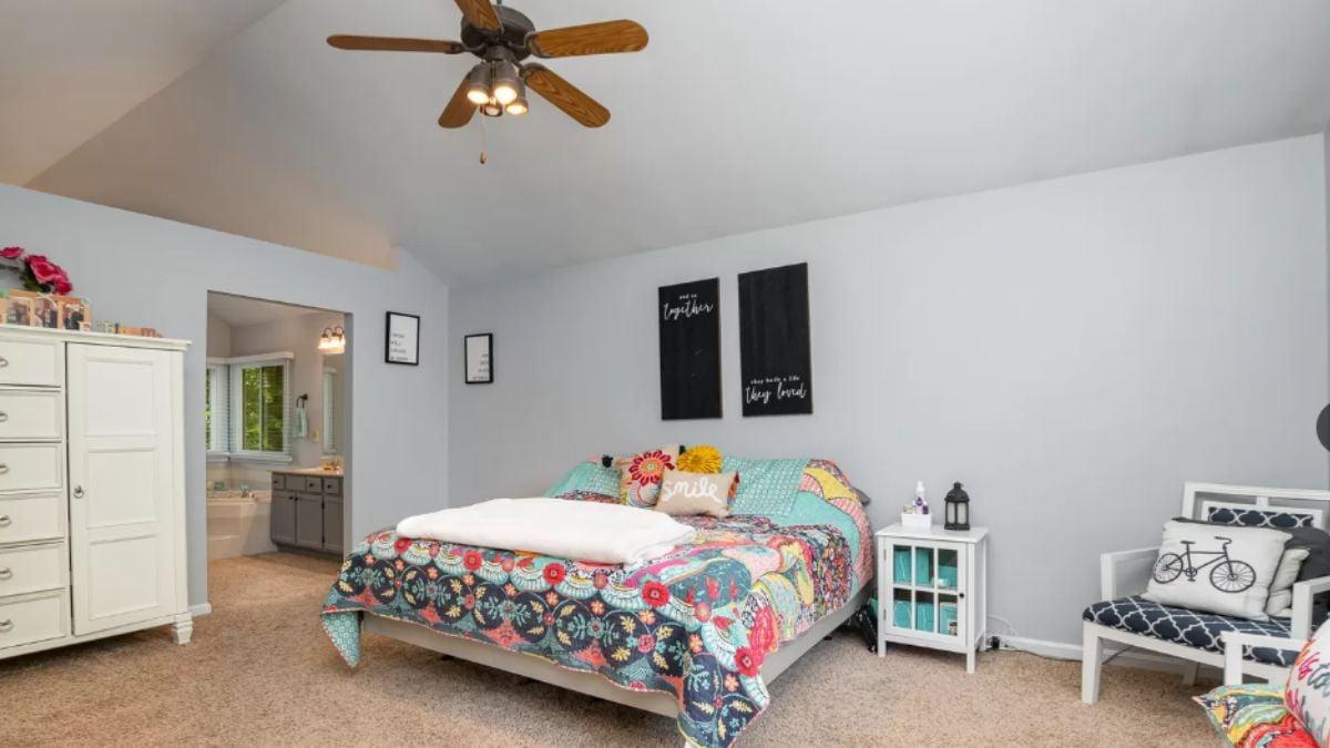 Bright Bedroom with a Colorful Quilt and Vaulted Ceiling