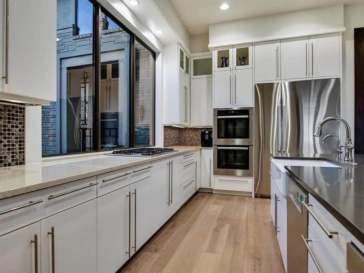 Sleek Kitchen with Expansive Windows and High-End Appliances