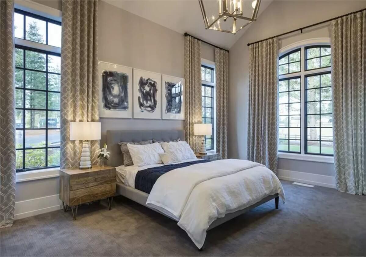 Admire the Vaulted Ceiling and Elegant Draperies in This Serene Bedroom