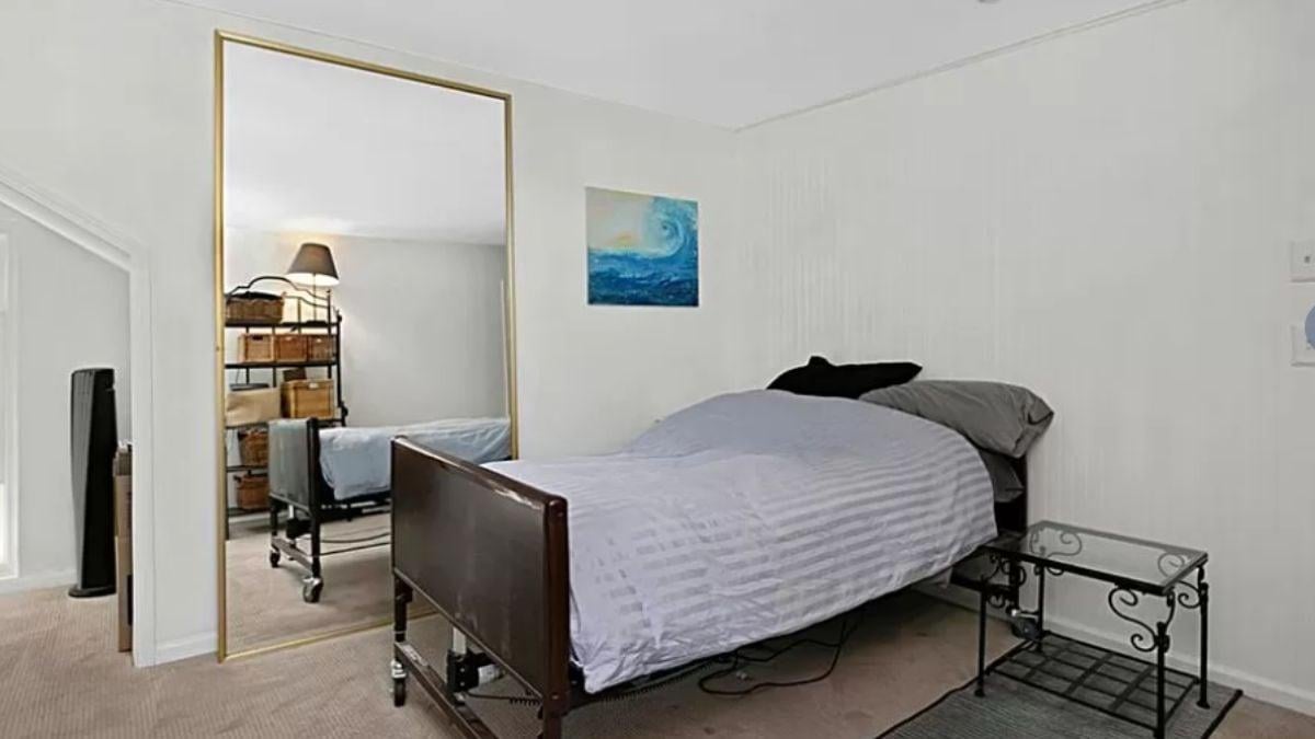Check Out the Oversized Mirror That Opens Up This Bedroom