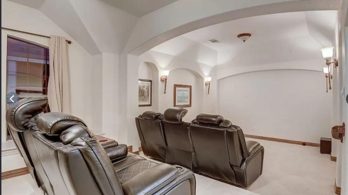 Settle Into This Cozy Media Room With Leather Recliners
