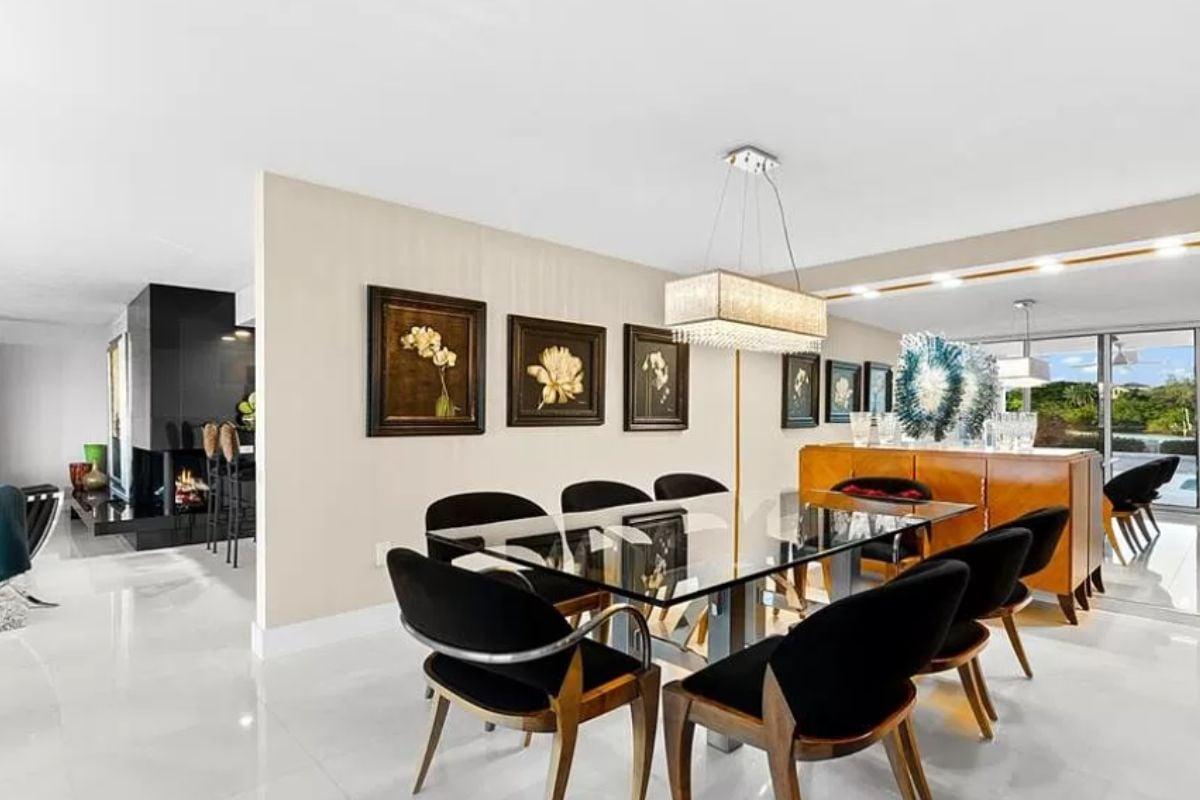 Feast Your Eyes on This Dining Room with Sleek Glass Table and Art Wall