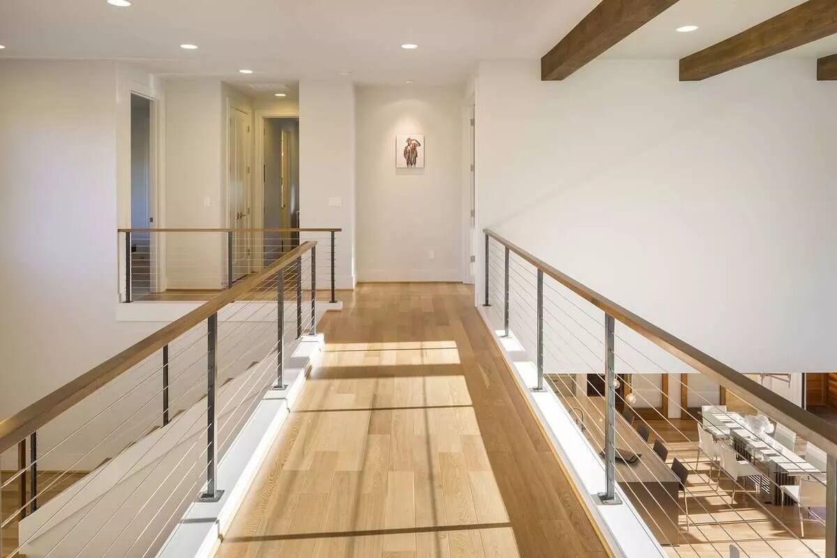 Light-Filled Hallway With a Sleek Cable Railing