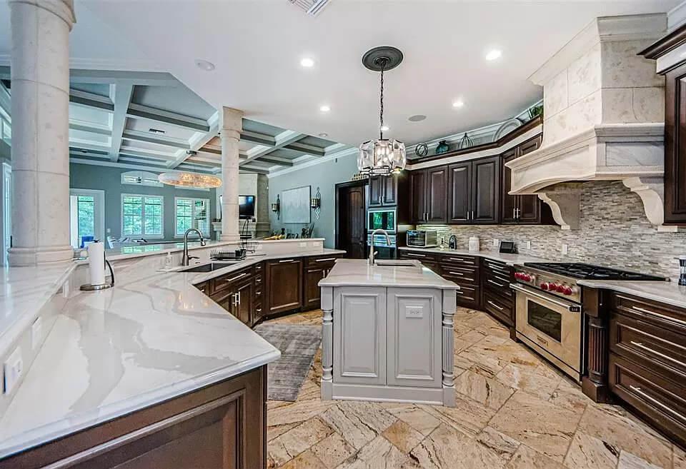 Gourmet Kitchen With Intricate Ceiling and Marble Counters