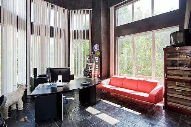 Check Out the Bold Red Sofa in This Sunlit Home Office