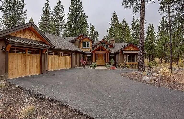 Charming Cedar and Stone Exterior with Forest Backdrop