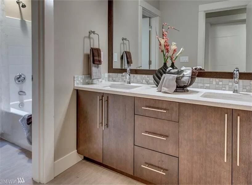 Double Vanity with Sleek Wood Finishes and Elegant Tile Backsplash