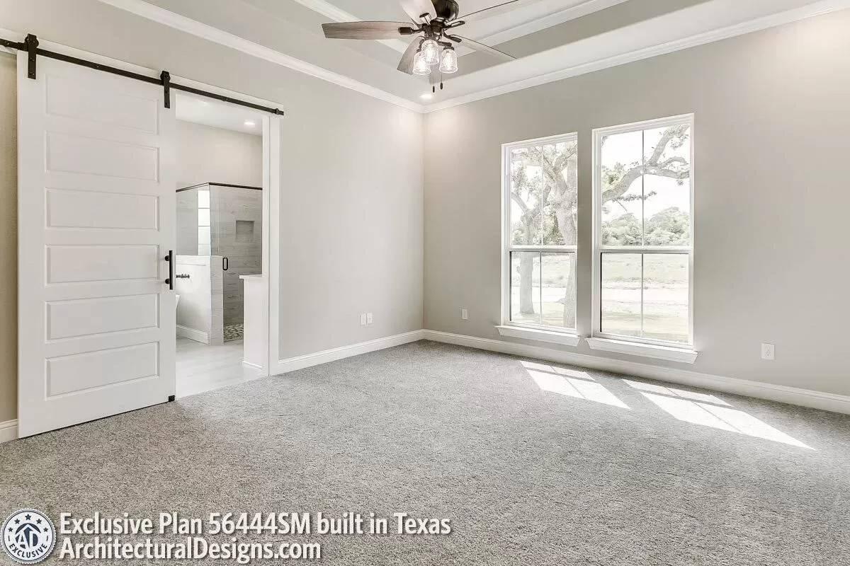 Check Out the Sleek Barn Door Leading to the Spacious Bathroom