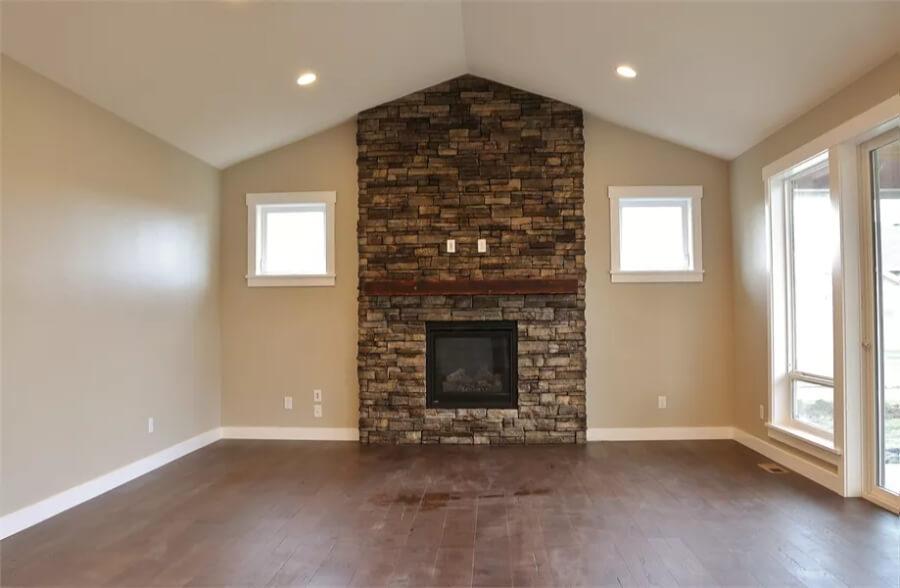 Vaulted Living Room Featuring a Stone Fireplace Centerpiece