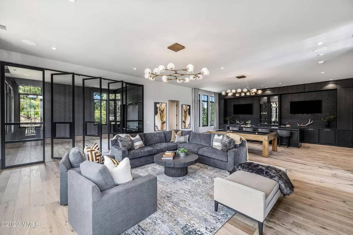 Explore the Sleek Game Room With Its Modern Chandelier
