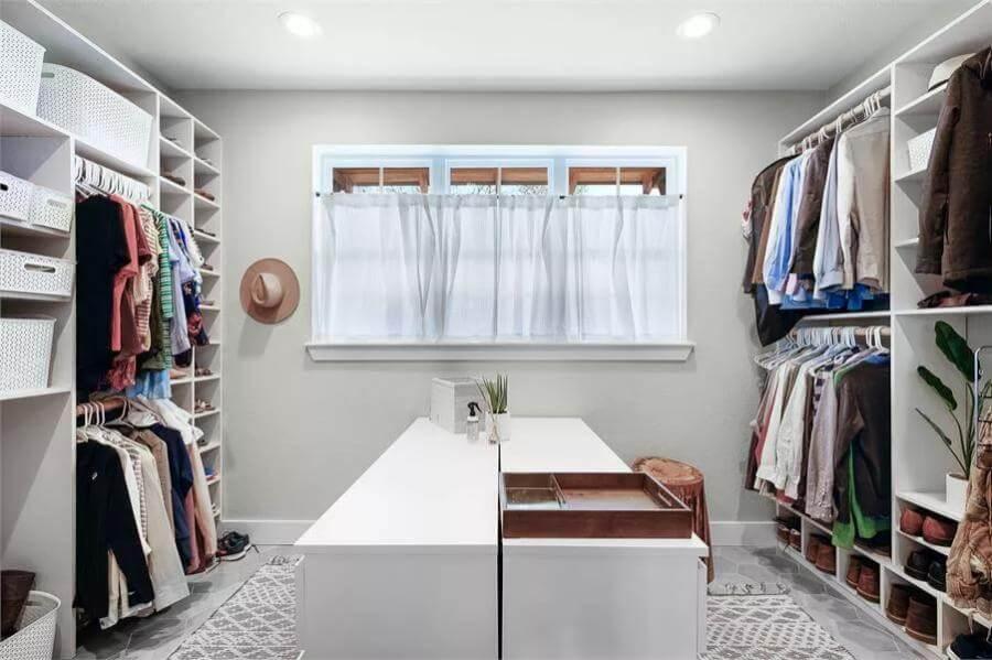 Organized Walk-In Closet with a Central Island for Enhanced Storage