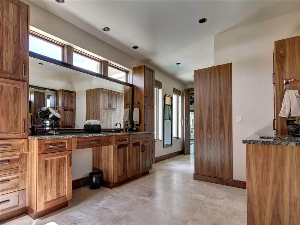Notice the Rich Wood Cabinetry in This Elegant Vanity Space