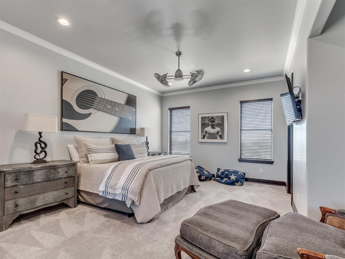 Chic Bedroom with Guitar Artwork and Bold Ceiling Fan