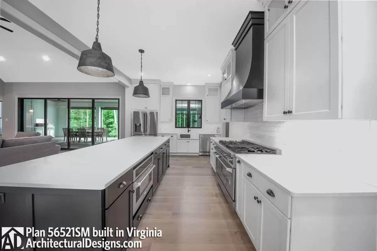 Sprawling Kitchen with a Bold Black Hood and Farmhouse Sink