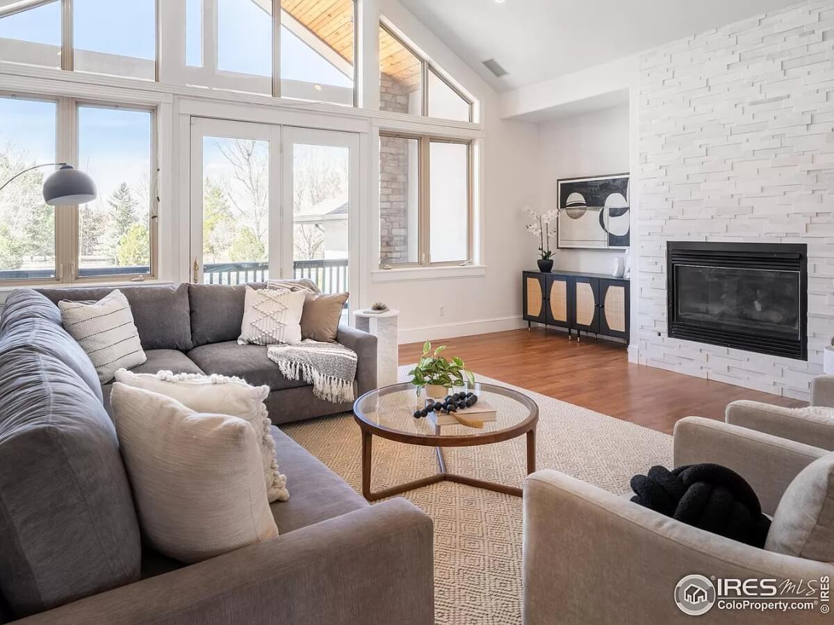 Bright Living Room with a Striking White Brick Fireplace