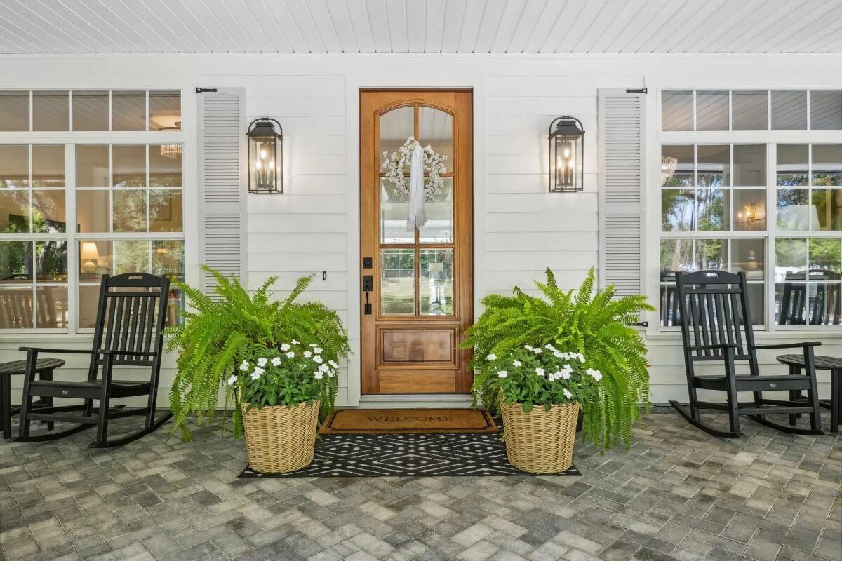 A Welcoming Craftsman Entry With Classic Rocking Chairs and Hanging Lanterns