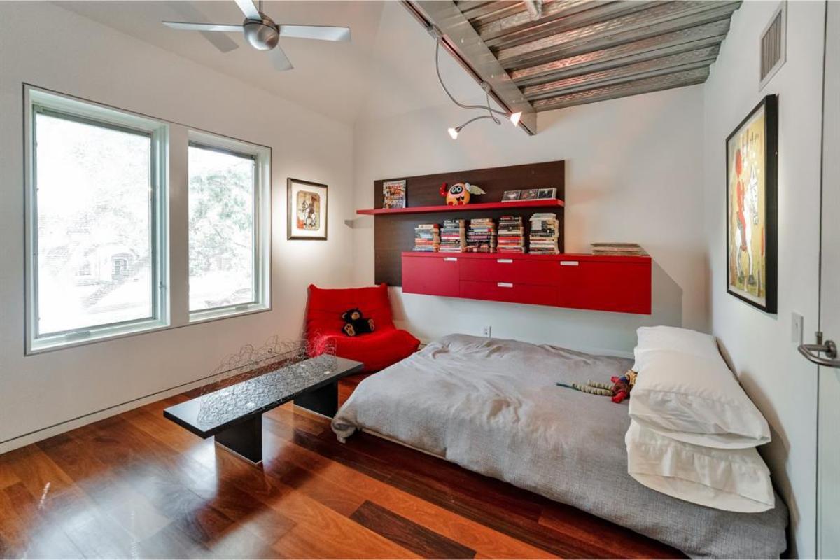Bold Red Accents and Industrial Ceiling in This Unique Bedroom