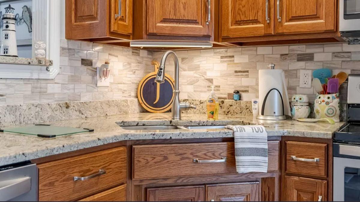 Wooden Cabinets Shine with Stone Backsplash in This Kitchen