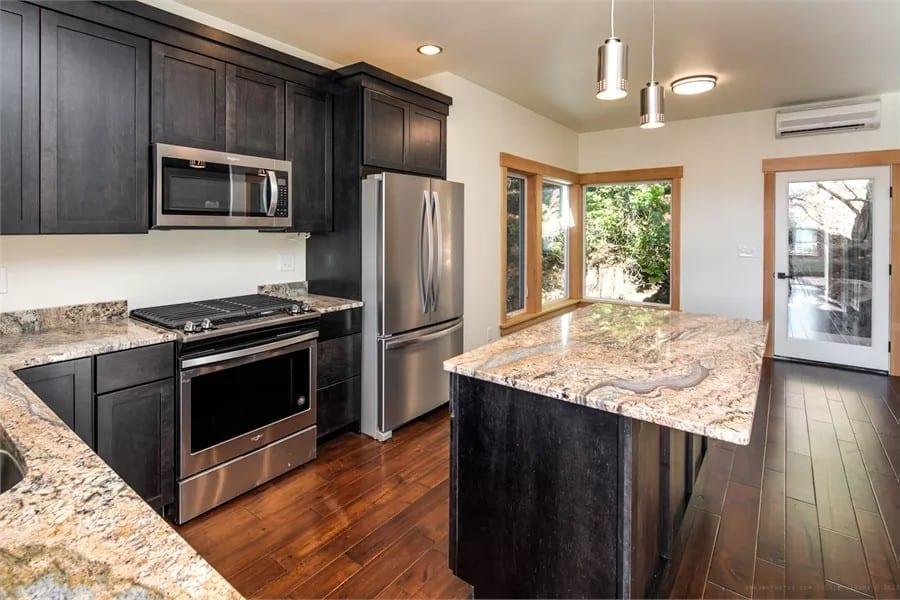 Modern Kitchen with Dark Cabinets and Stunning Granite Countertops