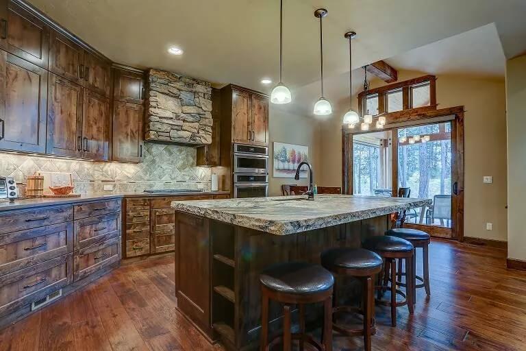 Craftsman Kitchen Showcasing a Striking Island with Stone Accents
