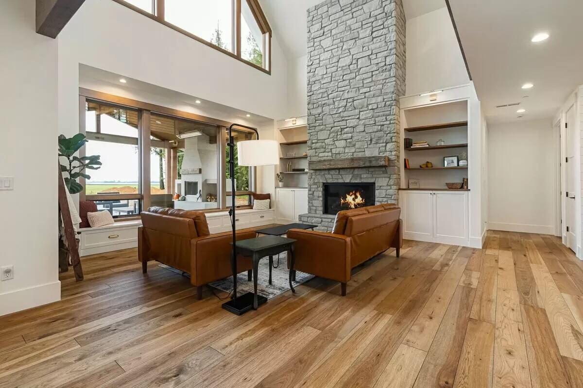 Warm Up by the Stone Fireplace in This Inviting Living Room