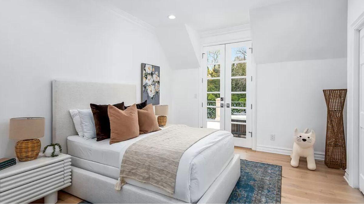 Bright Bedroom with French Doors Leading to a Private Balcony