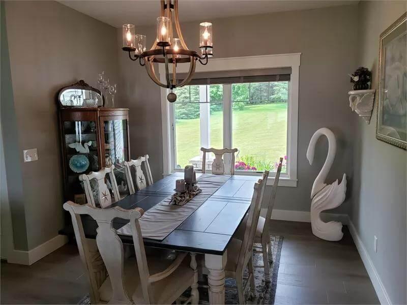 Captivating Dining Room with Glass-Front Hutch and Elegant Chandelier