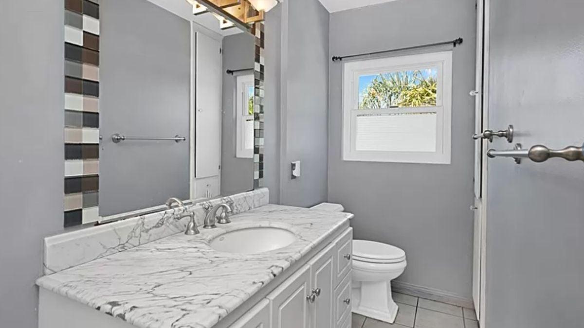 Notice How the Patterned Mirror Frame Enhances This Bathroom