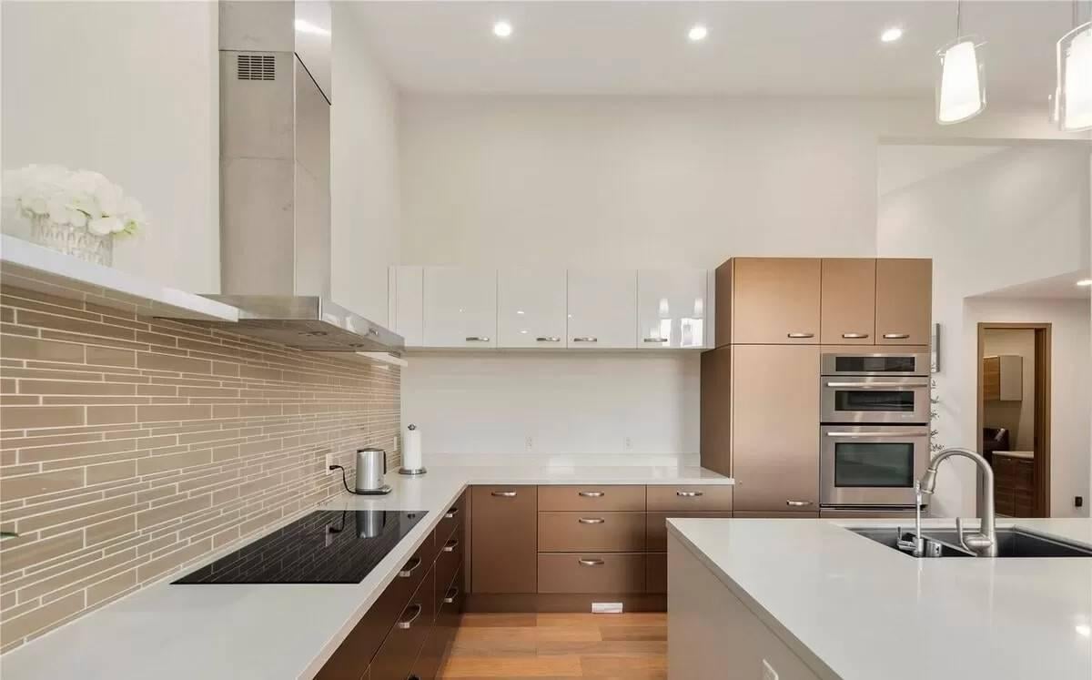 Spot the Sleek Upper Cabinets and Futuristic Backsplash in This Kitchen