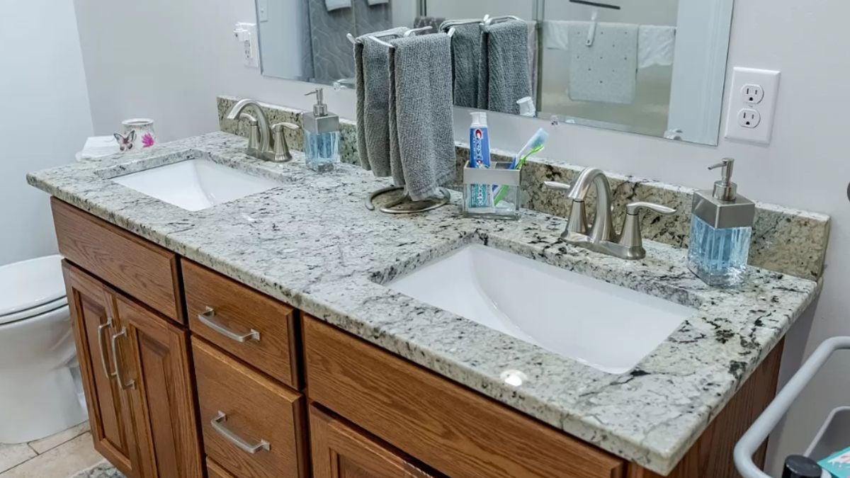 Dual Sinks Over Pristine Granite Highlight This Bathroom