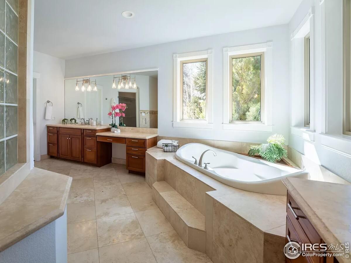 Luxurious Bathroom with an Elegant Sunken Tub and Three Tall Windows