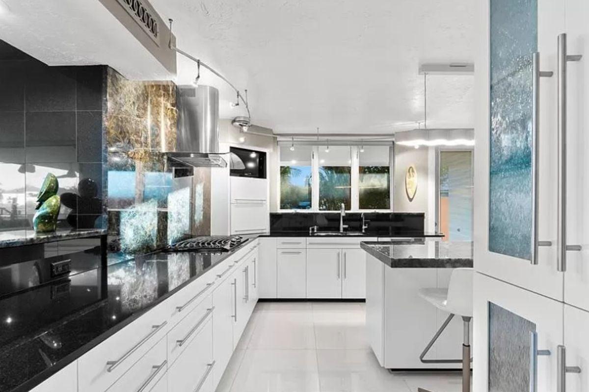 Check Out the Reflective Backsplash in This Sleek Kitchen