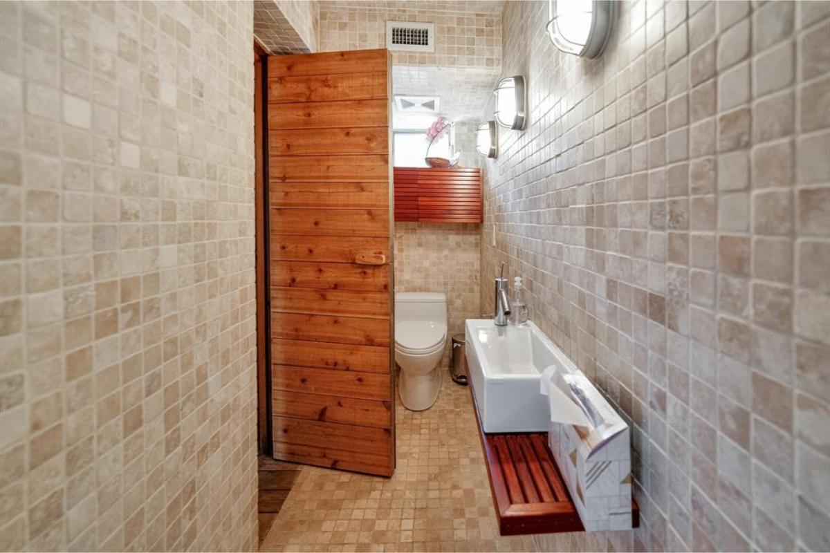 Rustic Bathroom with Tiled Walls and Wooden Accents